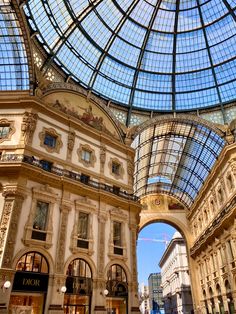 the inside of a shopping mall with glass ceiling