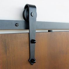 an image of a door handle on the side of a wooden door with metal handles