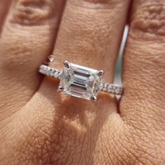 a woman's hand with a diamond ring on it