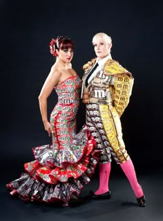 two people dressed in colorful clothing posing for a photo