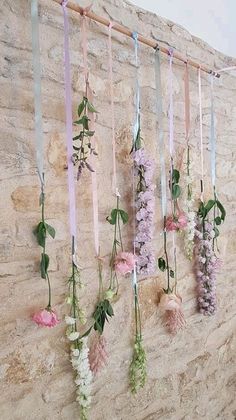 a wall with flowers hanging from it's sides