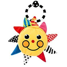 a stuffed toy with a smiley face and stars on it's head, hanging from a string