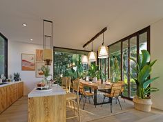 a dining room table and chairs with plants in the middle, near large glass windows