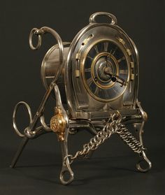 an antique clock with chains attached to it