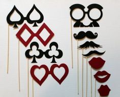 the photo booth is decorated with red and black paper mustaches, lips, and moustaches