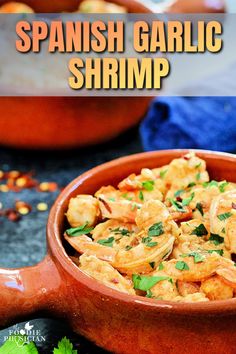 a bowl filled with shrimp and garnish on top of a table next to other food