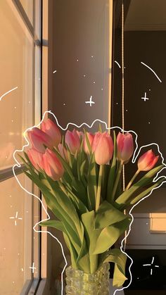 a vase filled with pink tulips sitting on top of a window sill