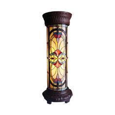 a stained glass lamp on top of a wooden stand with an ornate design in the center