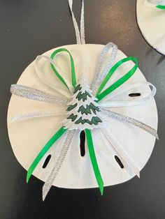 a paper plate with a green ribbon tied around it