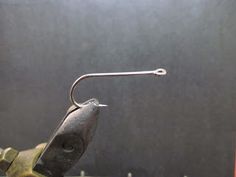 a fishing hook is attached to the end of a fish hook on a metal rod