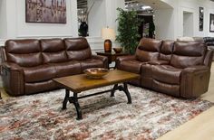 a living room with two couches, a coffee table and a rug on the floor