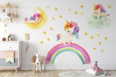 a child's room with unicorns and stars painted on the wall