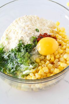 a bowl filled with rice, corn and an egg sitting on top of some other food