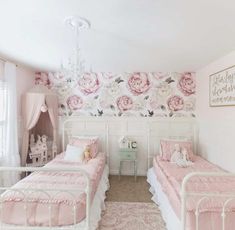 two twin beds in a girls'bedroom with pink and white decor