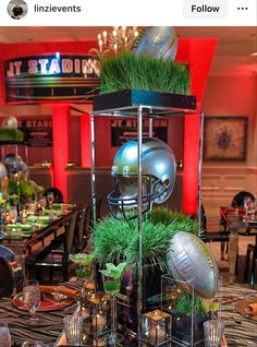 a table topped with lots of different types of footballs on top of each other