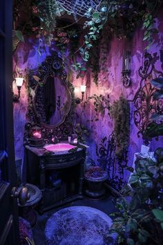 a bathroom decorated in purple and black with lots of greenery