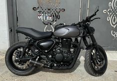 a black motorcycle parked in front of a building