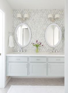 a white bathroom with two sinks and mirrors on the wall next to it is an instagram page