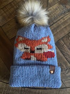 a knit hat with a fox on it