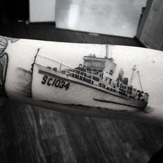 a black and white photo of a ship on someones arm with the word sc104 written in it