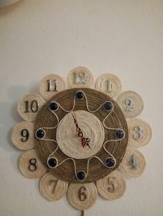 a clock made out of yarn with numbers on it