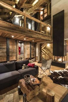 a living room filled with lots of furniture and a fire place in the middle of it