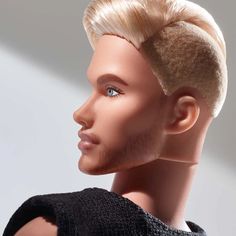 a male mannequin head with blonde hair and blue eyes wearing a black sweater