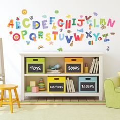 a child's room with toys and letters on the wall