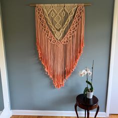 the wall hanging is decorated with fringes and flowers