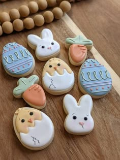 decorated cookies are sitting on a wooden table