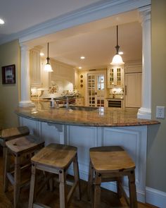 a kitchen with an island and stools in it