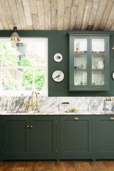 a kitchen with green cabinets and white marble counter tops, along with an instagram ad for instagram