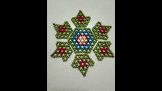 a beaded snowflake with red, green and blue beads on it's side