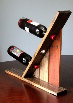 a wooden wine rack with two bottles in it