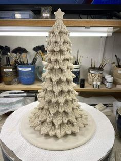 a ceramic christmas tree sitting on top of a table