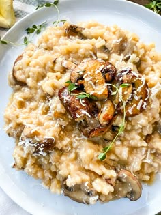 a white plate topped with riso and mushrooms