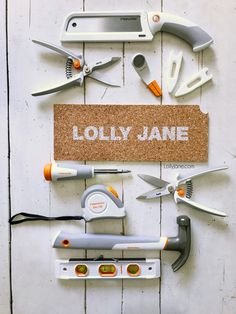 various tools are laid out on top of a cork board that says, lolly jane