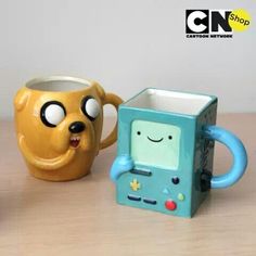 two mugs with faces on them sitting next to each other