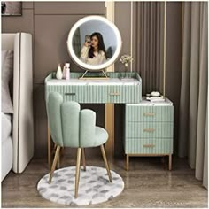 a woman taking a selfie in front of a vanity with a mirror and chair