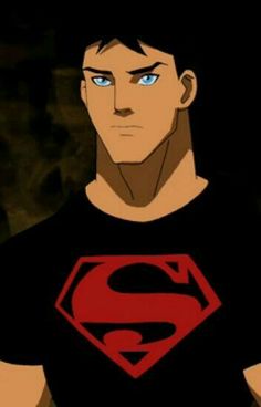 a man with blue eyes and a superman t - shirt is staring at the camera