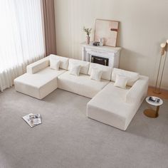 a living room with a large white sectional couch