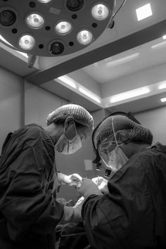 two surgeons are performing surgery in an operating room