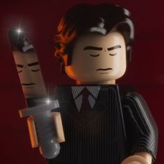 a lego man holding a knife and wearing a suit with his eyes closed, in front of a red background