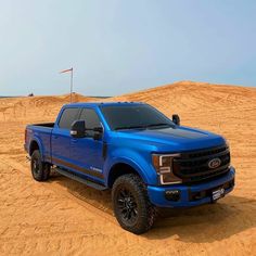 a blue truck is parked in the desert