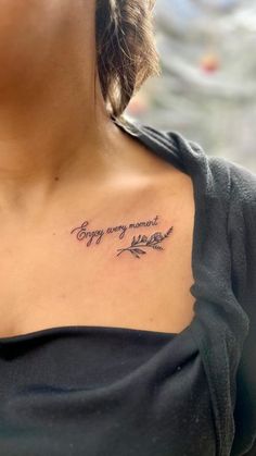 a woman with a tattoo on her chest that says, enjoy every moment and be grateful