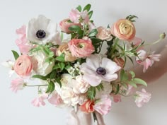 a vase filled with lots of pink and white flowers