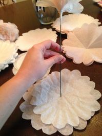 someone is making paper flowers on the table