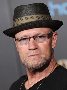 an older man wearing glasses and a hat