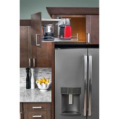 a stainless steel refrigerator freezer sitting inside of a kitchen