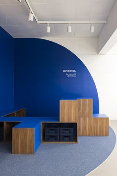 an empty room with blue walls and wooden shelves